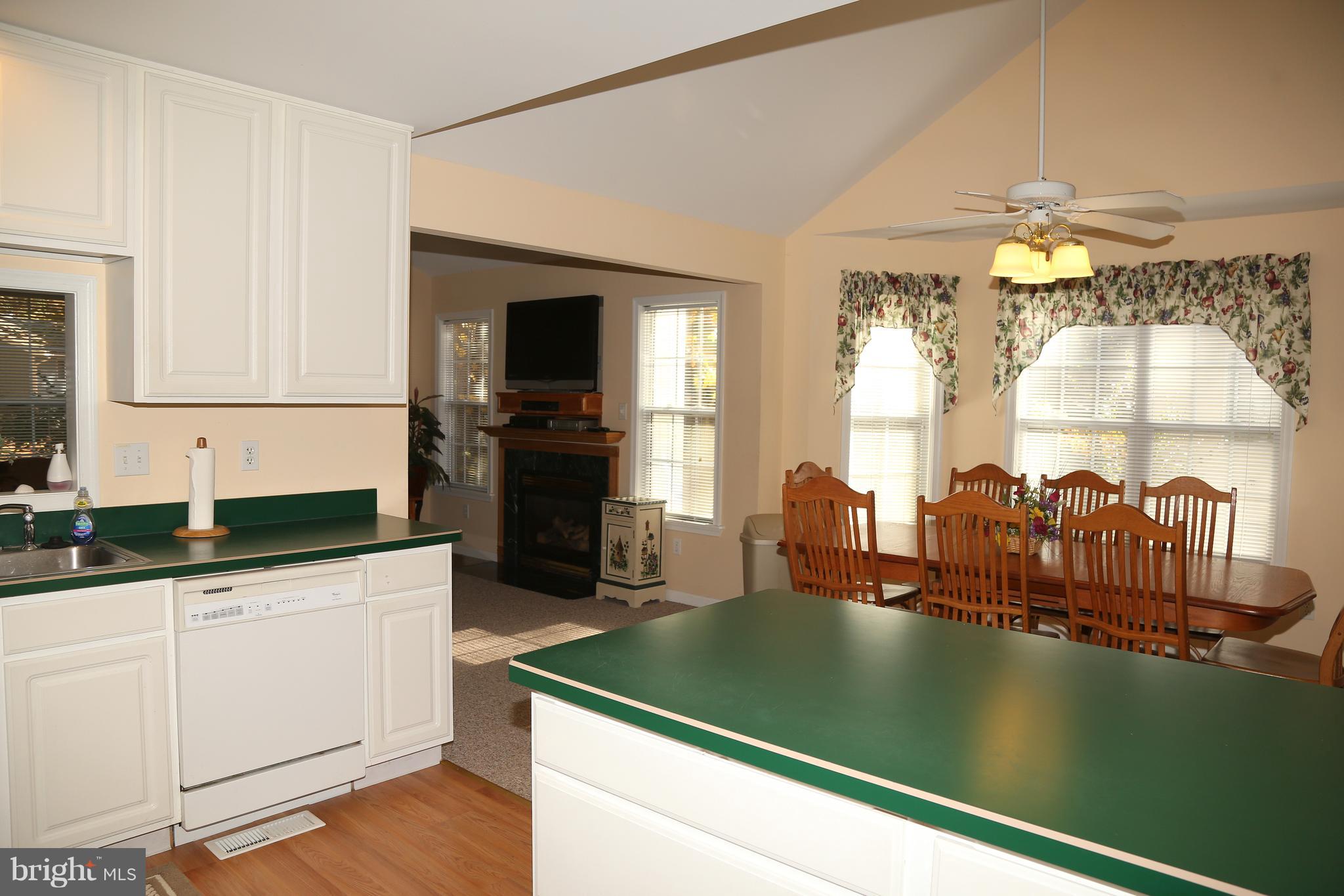 43 Falcon Bridge Road Ocean Pines, MD 21811 - Photo 6 of 30 a kitchen with a sink dishwasher and a stove with wooden floor