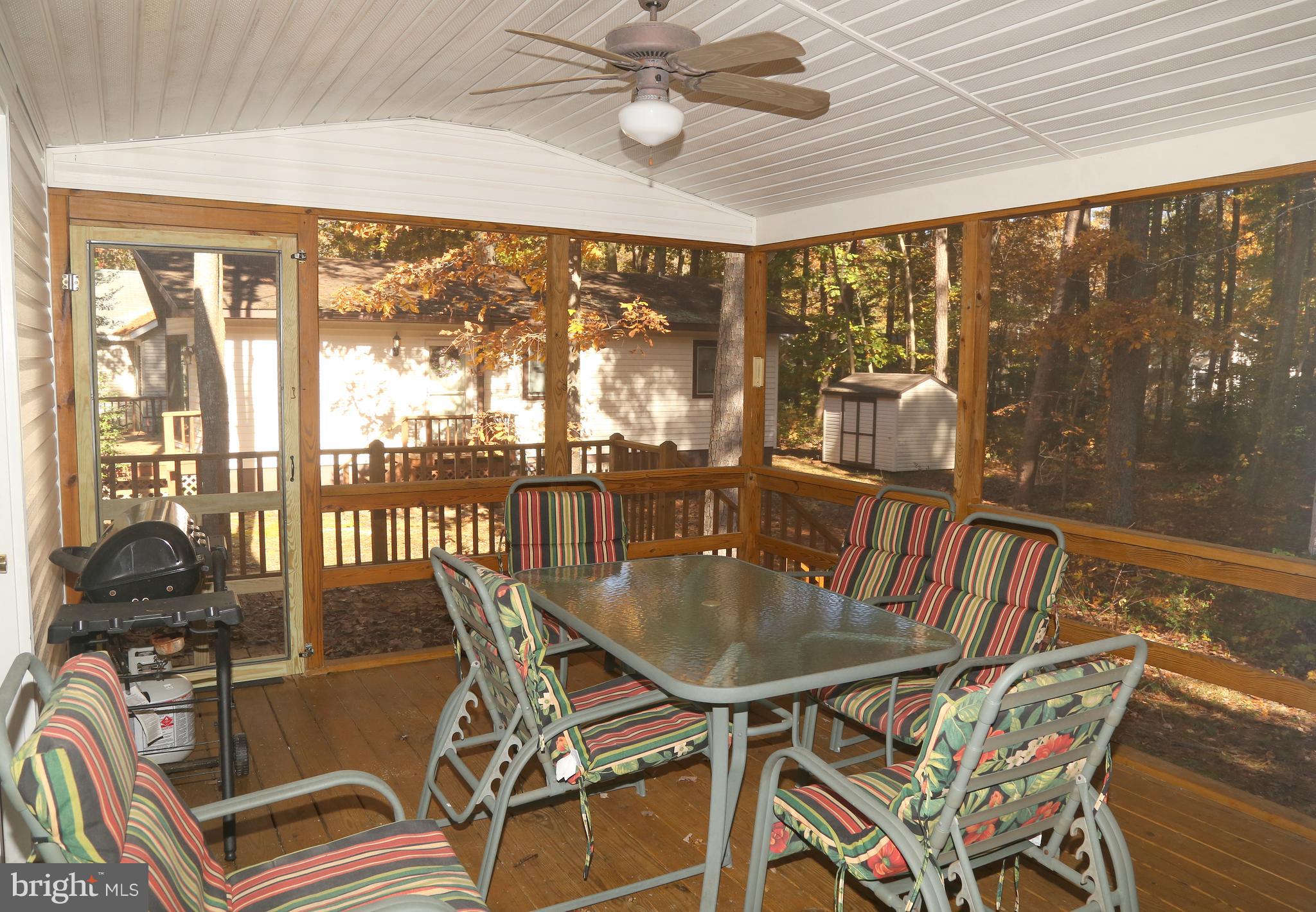 43 Falcon Bridge Road Ocean Pines, MD 21811 - Photo 10 of 30 a view of a dining room with furniture large windows and wooden floor