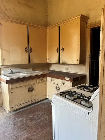 a kitchen with stainless steel appliances granite countertop a sink stove and microwave