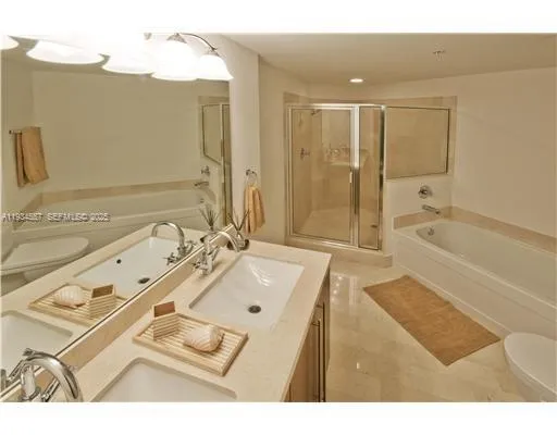 a bathroom with a tub sink and mirror