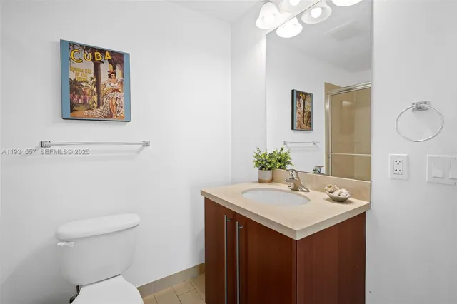 a bathroom with a sink vanity and a toilet
