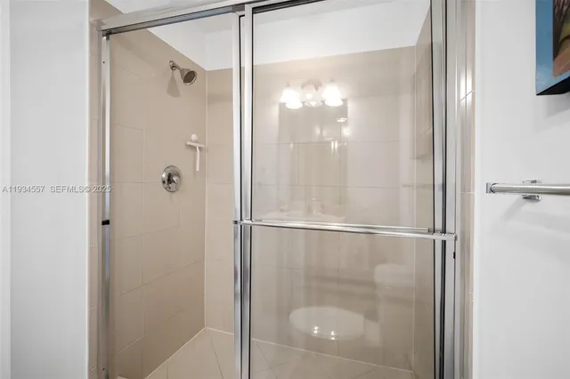 a bathroom with a glass shower door
