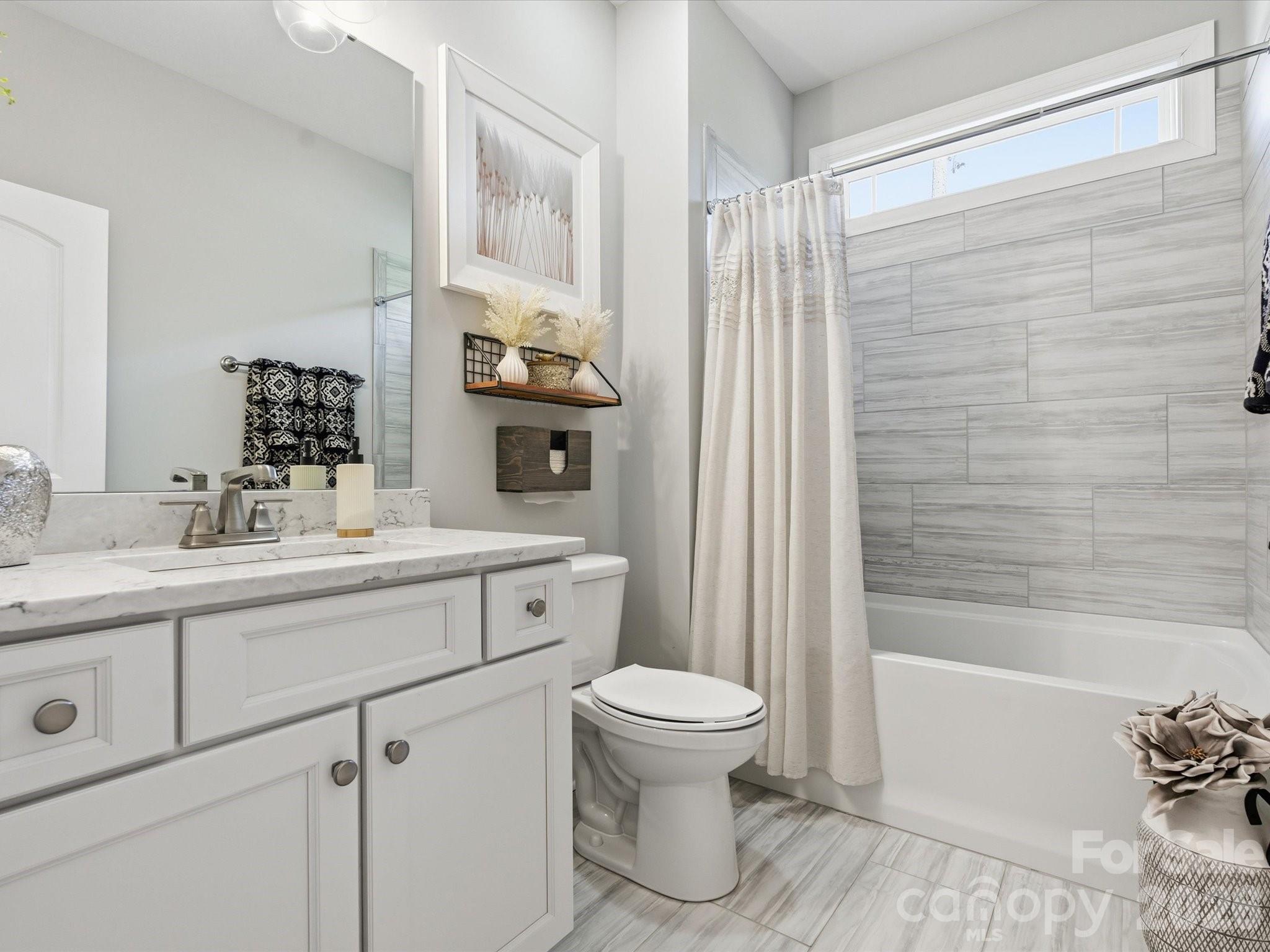 4166 Persimmon Road Lancaster, SC 29720 - Photo 22 of 41 a bathroom with a sink a toilet and shower