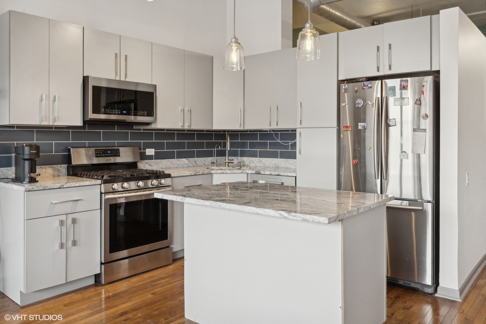 500 South Clinton Street, Unit 227 Chicago, IL 60607 - Photo 2 of 20 a kitchen with stainless steel appliances granite countertop a refrigerator stove and sink