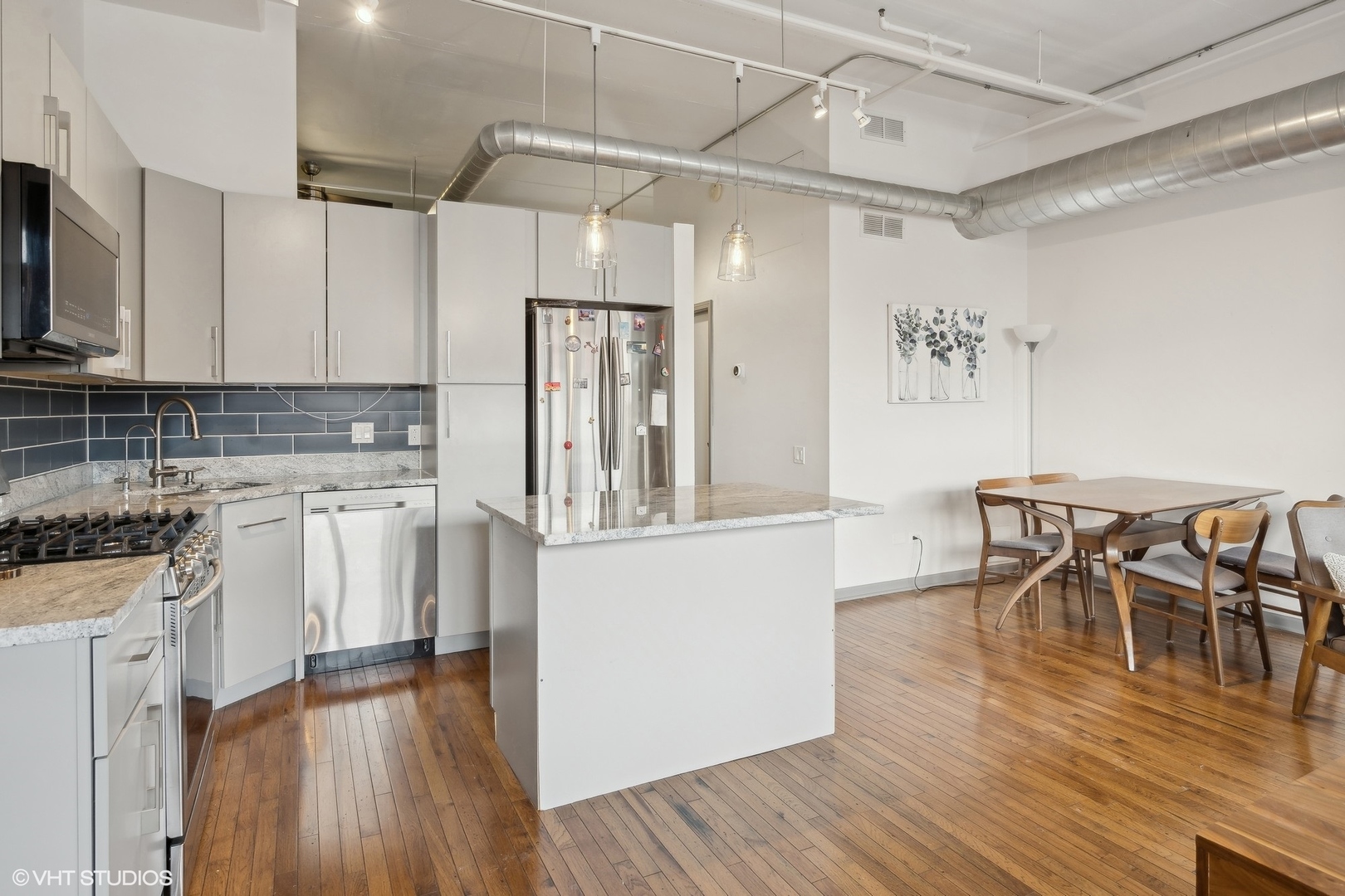 500 South Clinton Street, Unit 227 Chicago, IL 60607 - Photo 3 of 20 a kitchen with white cabinets and stainless steel appliances