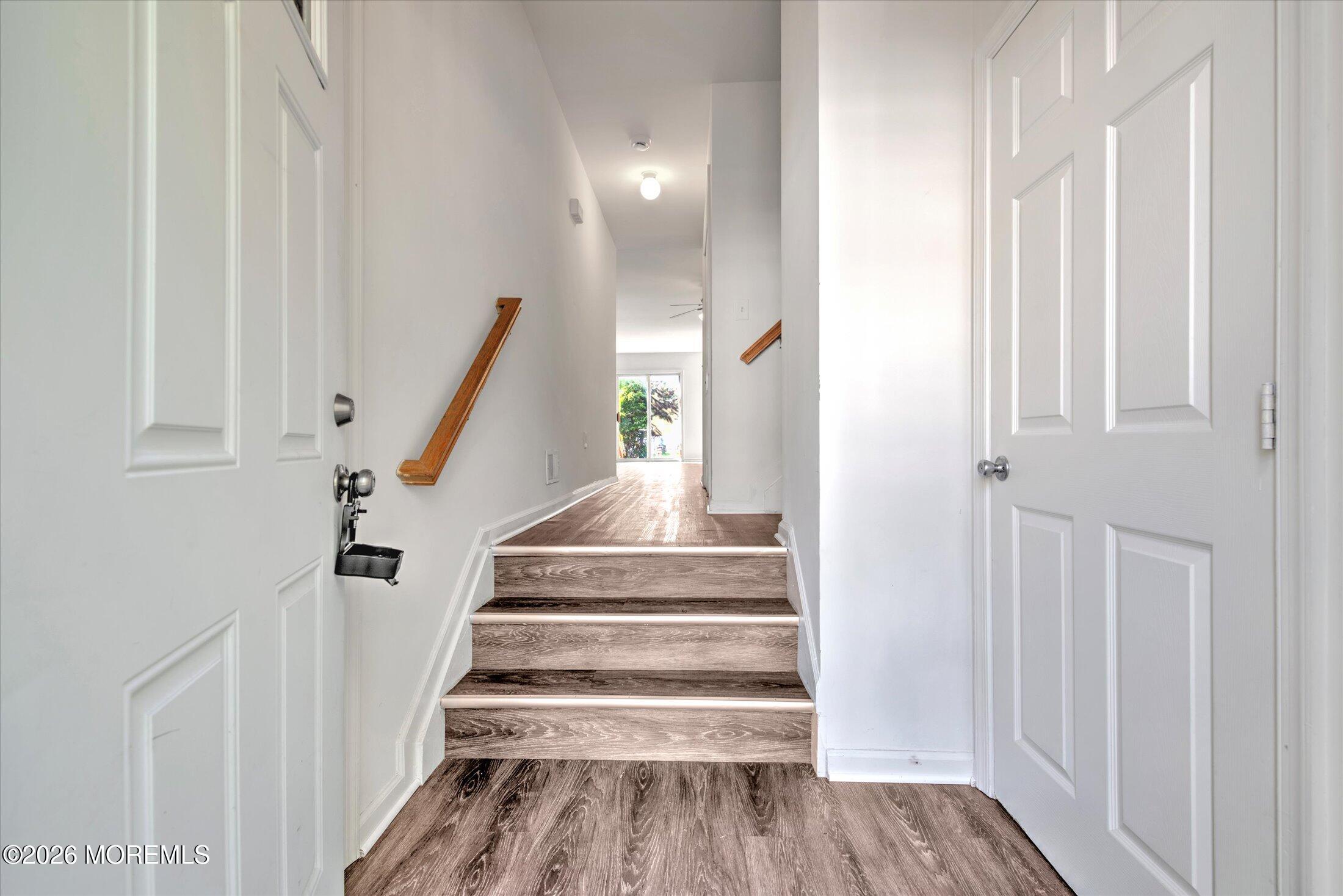 26 Esplanade Way Bayville, NJ 08721 - Photo 13 of 41 a view of a hallway with wooden floor and staircase