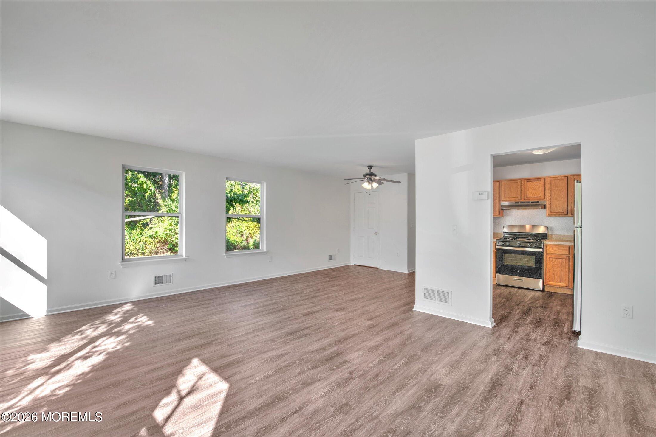 26 Esplanade Way Bayville, NJ 08721 - Photo 19 of 41 wooden floor in an empty room with a window