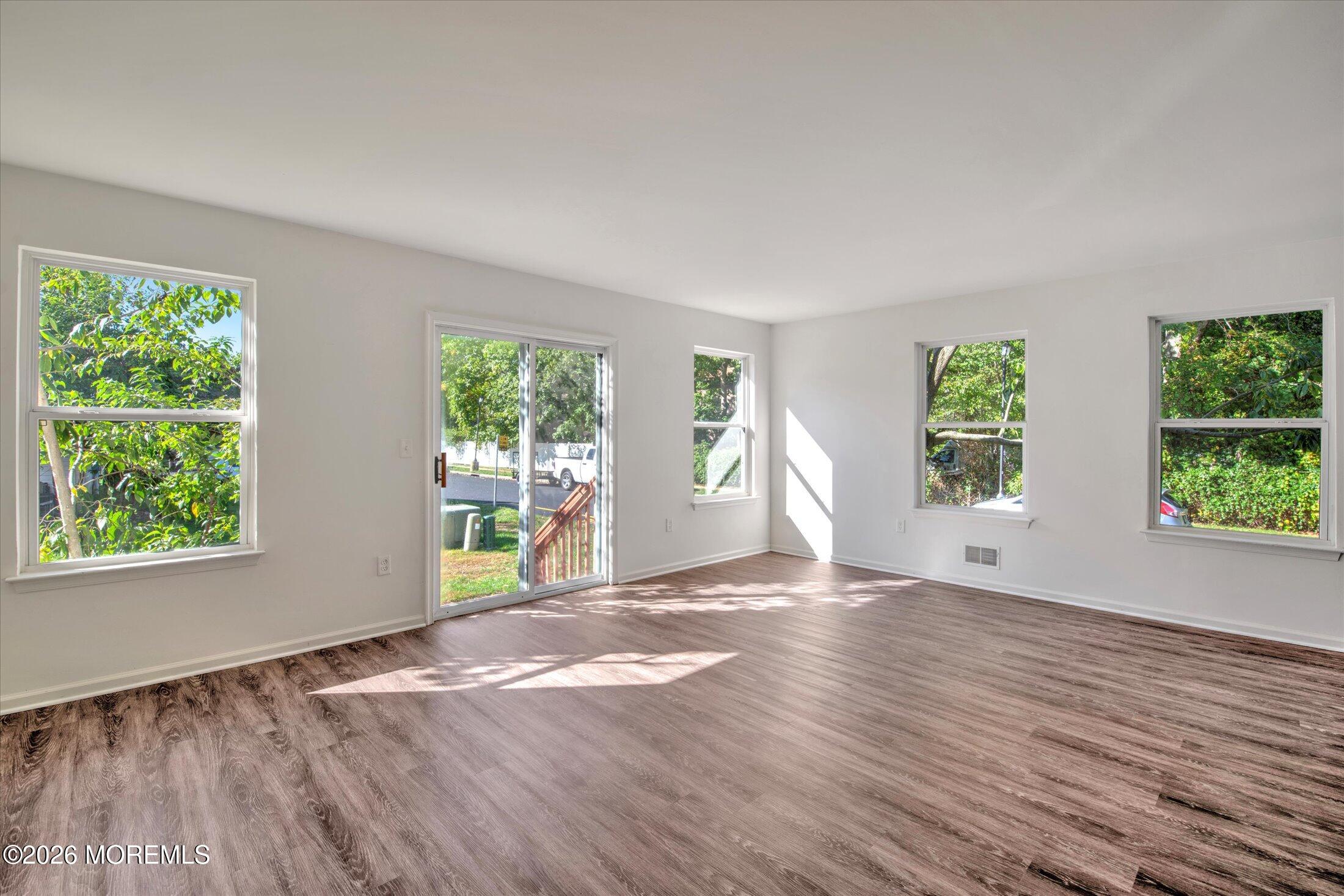 26 Esplanade Way Bayville, NJ 08721 - Photo 21 of 41 a view of an empty room with wooden floor and a window