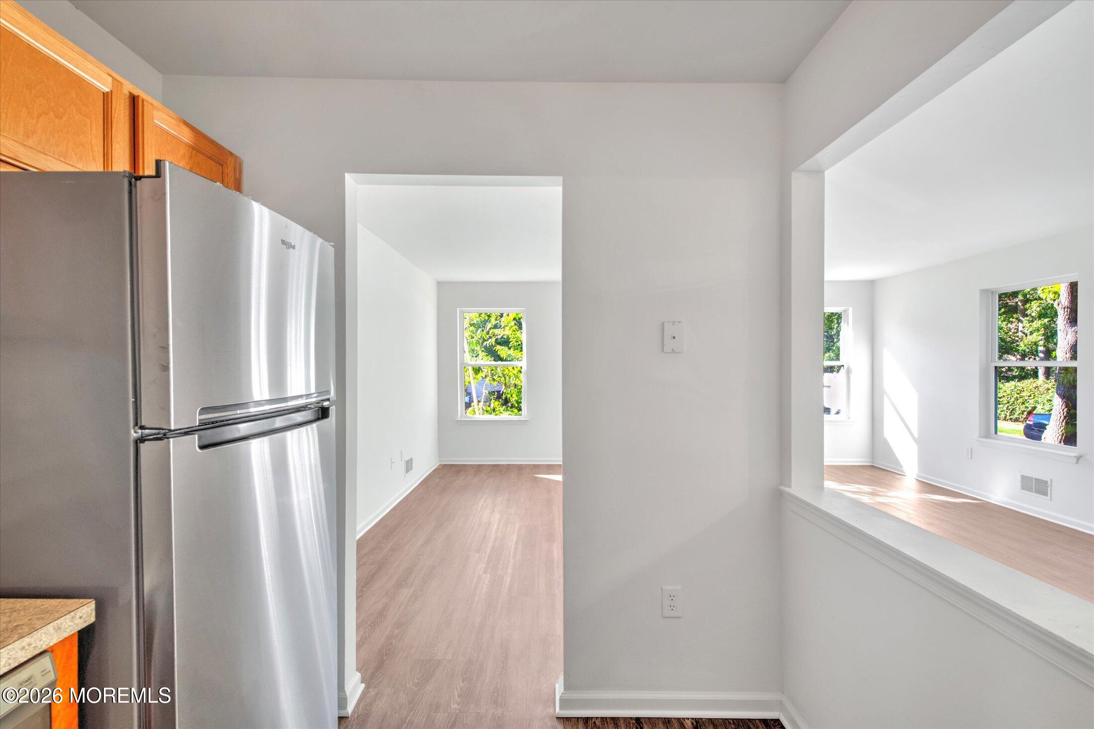 26 Esplanade Way Bayville, NJ 08721 - Photo 4 of 41 a view of an empty room with window and wooden floor