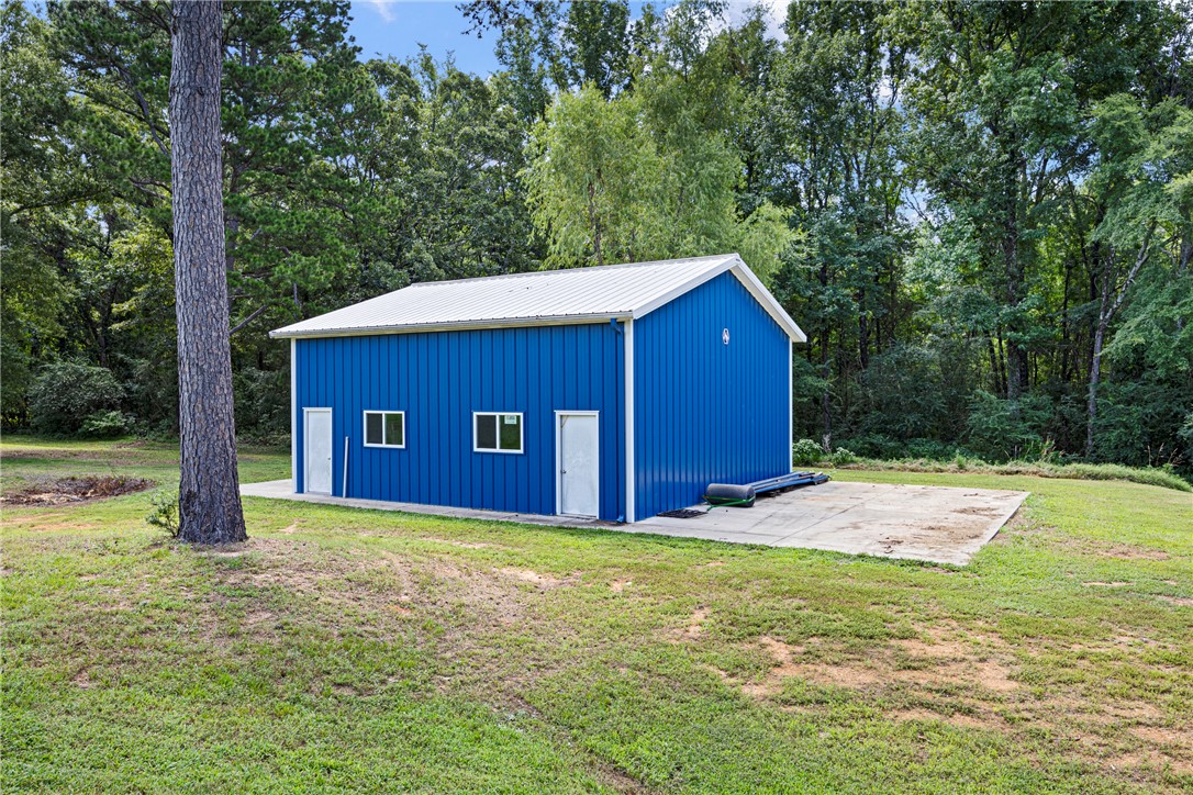 751 Walthall Road Russellville, AR 72802 - Photo 51 of 60 Metal-sided building featuring a bright blue exterior and a white gabled roof