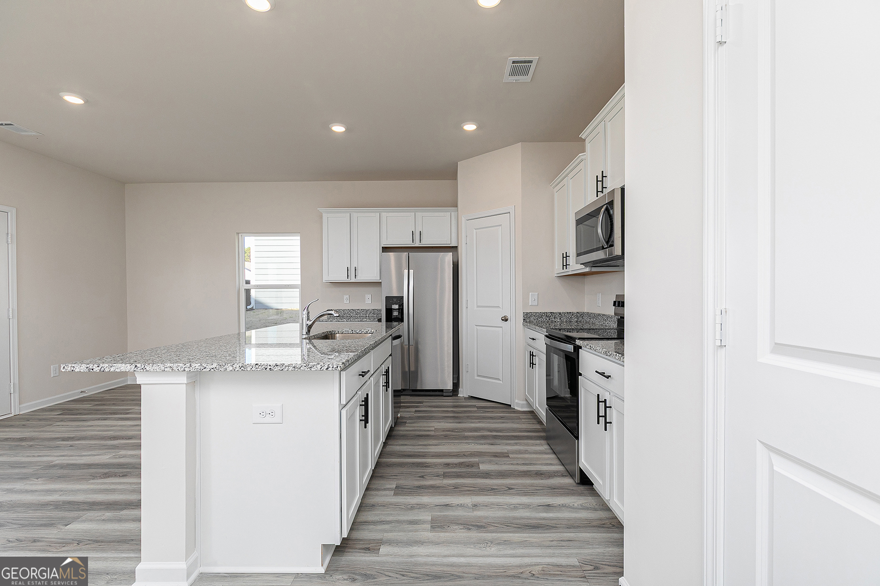 482 Prescott Way Villa Rica, GA 30180 - Photo 7 of 17 a kitchen with stainless steel appliances granite countertop a stove top oven a sink and dishwasher