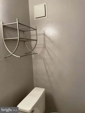 a white toilet sitting next to a shower
