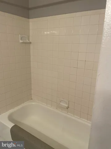 a bathroom with a shower and a bath tub