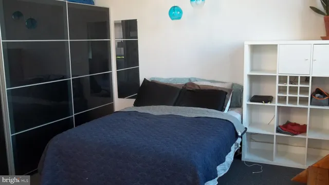 a view of bedroom with window and wooden floor