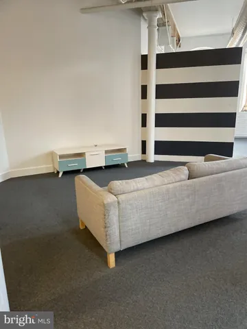 a living room with couches and a flat screen tv