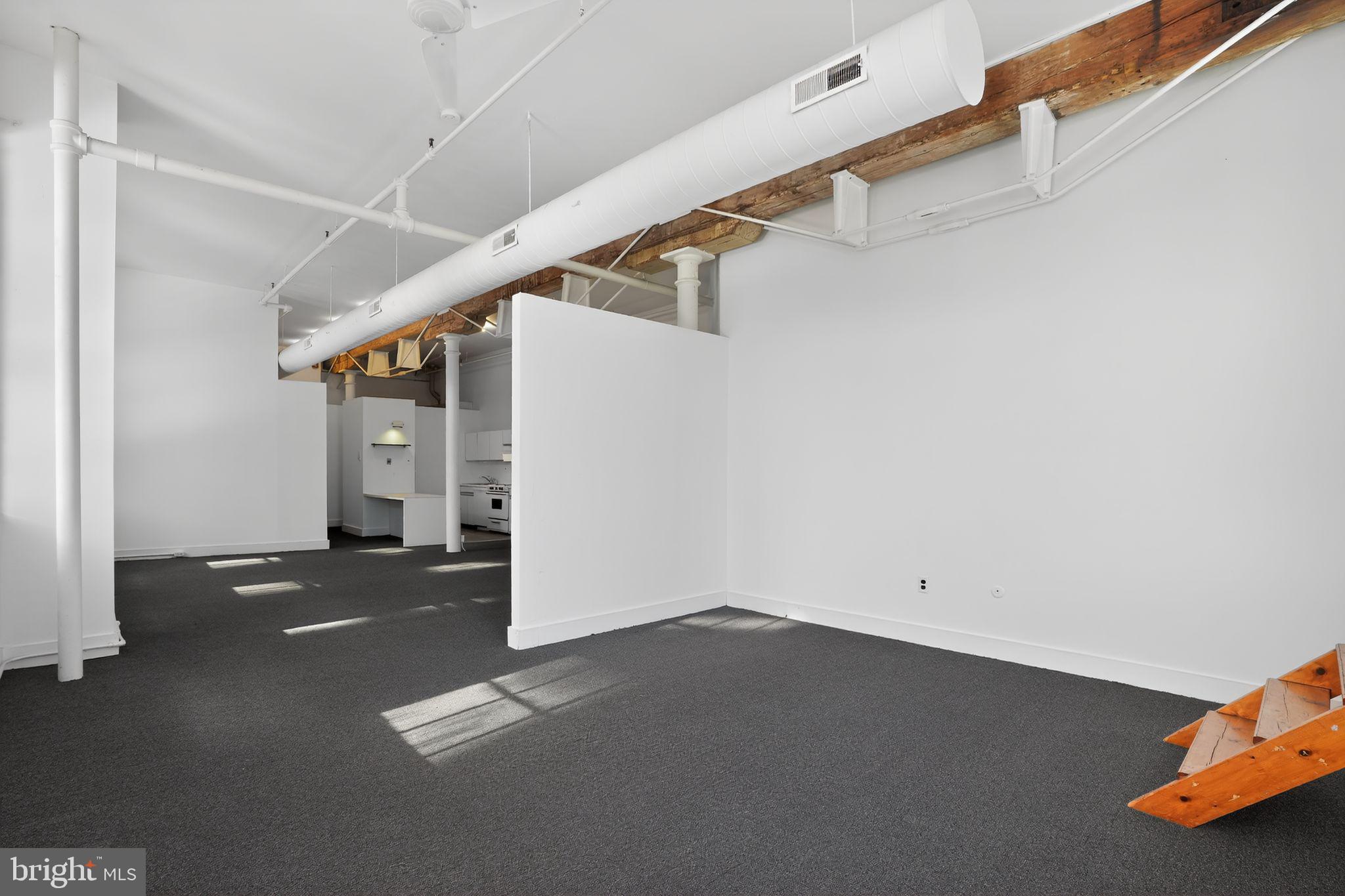 408 Vine Street, Unit 2A Philadelphia, PA 19106 - Photo 5 of 19 a view of a room with wooden floor and stairs