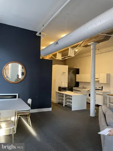 a work room with furniture and view of living room