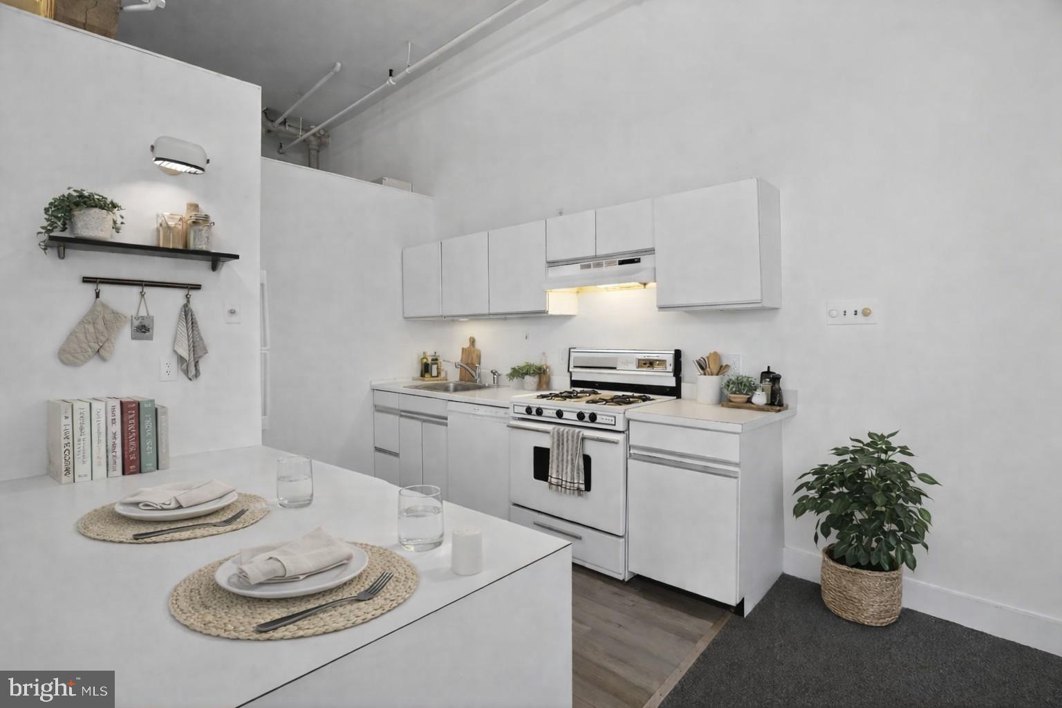 408 Vine Street, Unit 2A Philadelphia, PA 19106 - Photo 9 of 19 a kitchen with stainless steel appliances a sink a stove and white cabinets