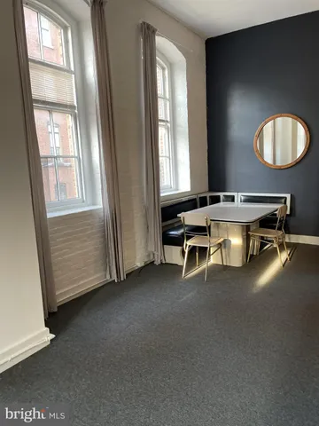 a view of a livingroom with furniture and a large window