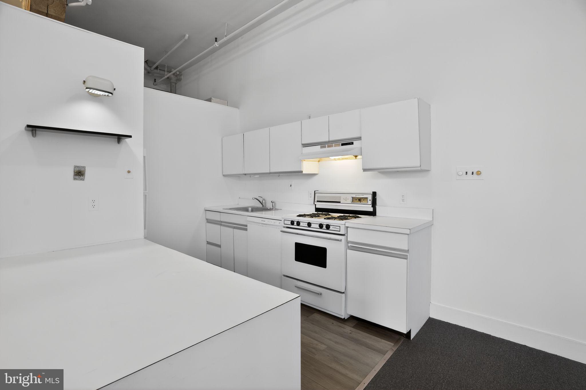 408 Vine Street, Unit 2A Philadelphia, PA 19106 - Photo 10 of 19 a kitchen with white cabinets and white appliances