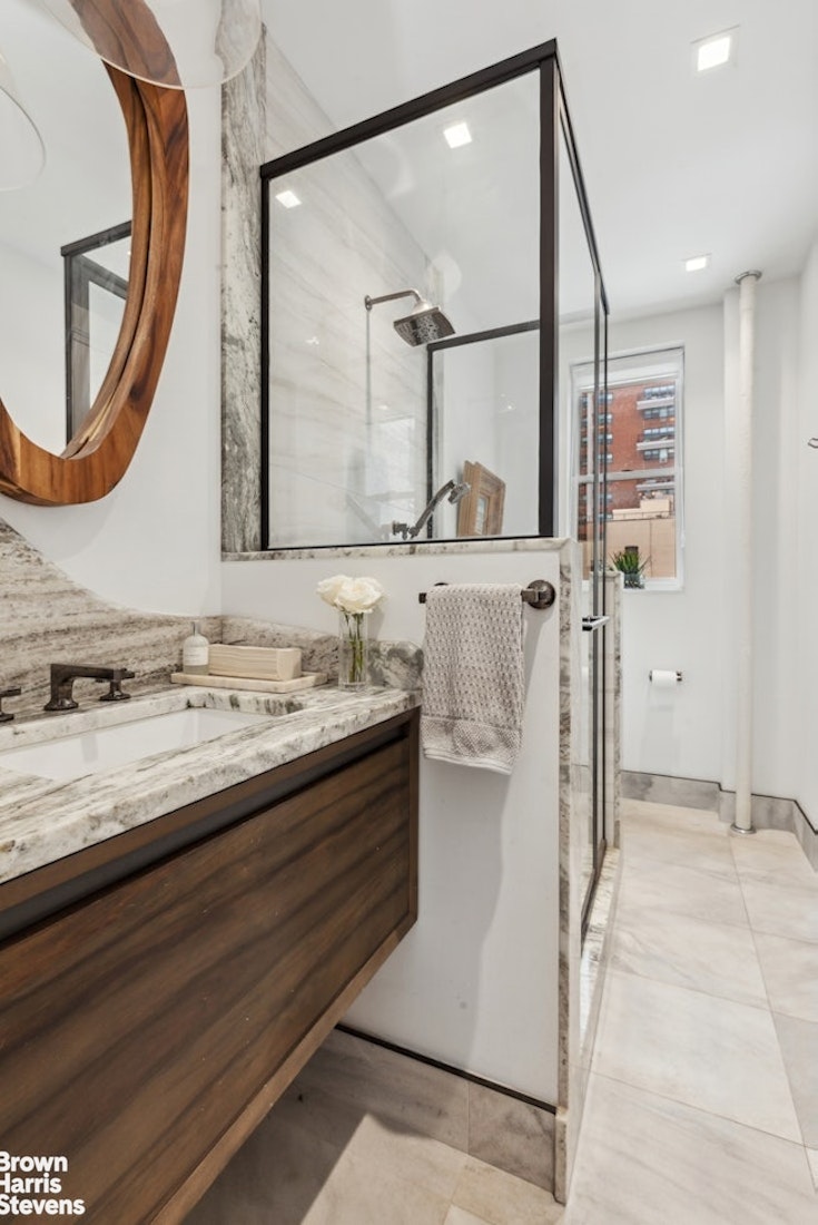 37 West 93rd Street, Unit 17/13 Manhattan, NY 10025 - Photo 10 of 11 a bathroom with a granite countertop sink a mirror and a bathtub