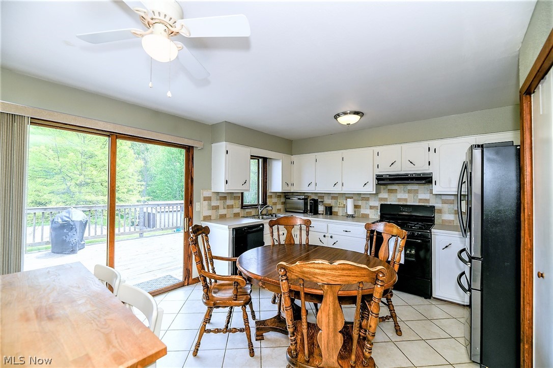 4425 Max Road North Canton, OH 44720 - Photo 10 of 30 *EAT IN KITCHEN W/CEILING FAN, SLIDERS TO THE BACK DECK, CERAMIC TILED FLOORING CURRENTLY HOUSING TWO DINING TABLES, SO PLENTY OF ROOM FOR AN EAT IN AREA! ~