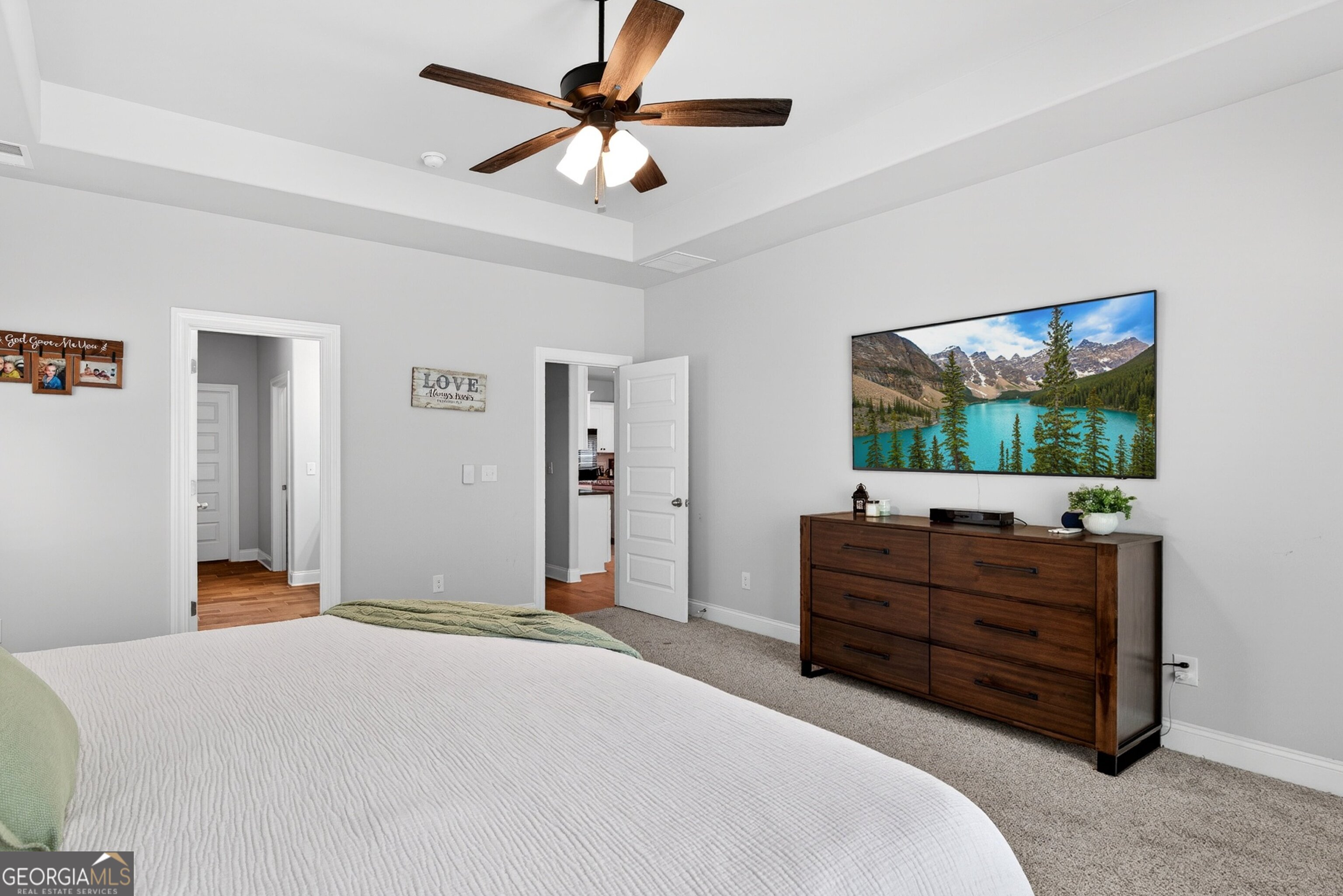 1764 Luther Bailey Road Senoia, GA 30276 - Photo 21 of 63 a bedroom with a bed and a flat screen tv