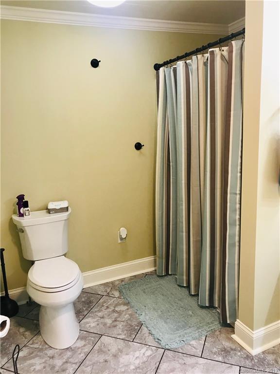 114 Riverview Road Tryon, NC 28782 - Photo 13 of 32 a white toilet sitting next to a bathroom sink