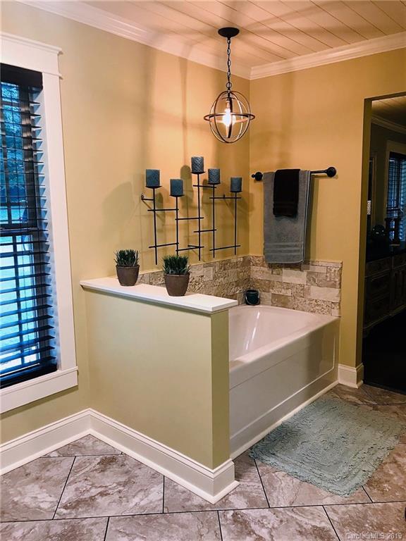 114 Riverview Road Tryon, NC 28782 - Photo 15 of 32 a bathroom with a tub and a shower