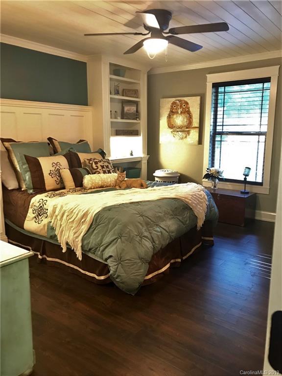 114 Riverview Road Tryon, NC 28782 - Photo 18 of 32 a bedroom with a bed and wooden floor
