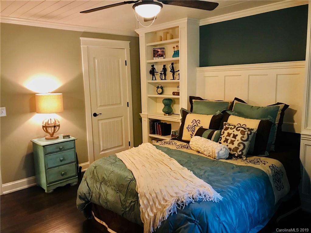 114 Riverview Road Tryon, NC 28782 - Photo 19 of 32 a bedroom with a bed and flat screen tv