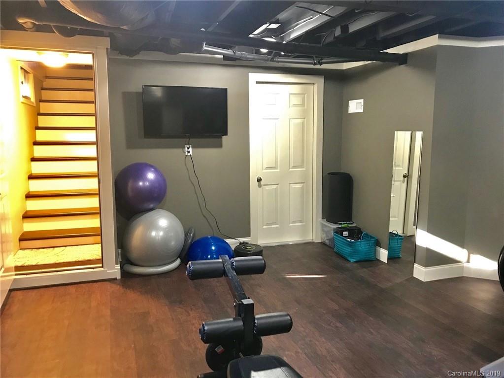 114 Riverview Road Tryon, NC 28782 - Photo 24 of 32 a room with wooden floor and gym equipment