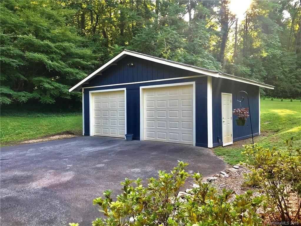 114 Riverview Road Tryon, NC 28782 - Photo 28 of 32 a front view of a house with garden