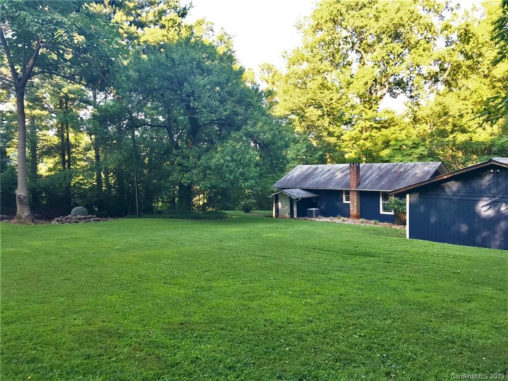 114 Riverview Road Tryon, NC 28782 - Photo 29 of 32 a view of a house with a garden