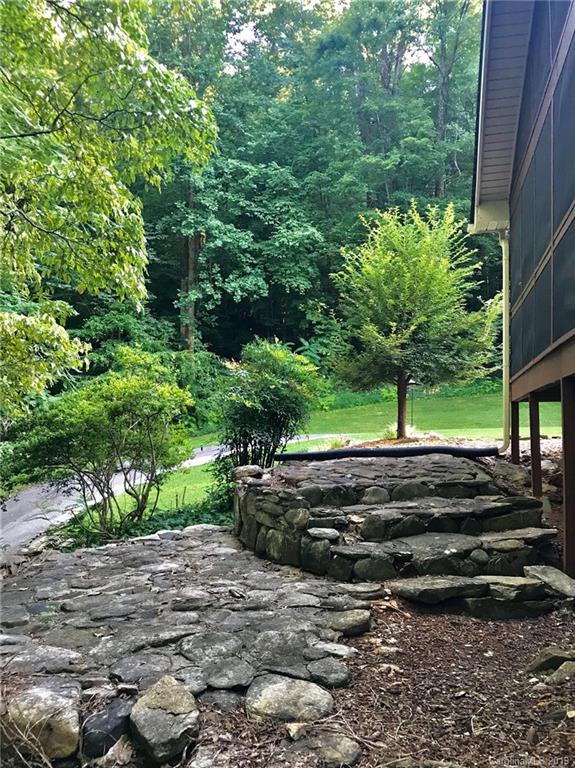 114 Riverview Road Tryon, NC 28782 - Photo 30 of 32 a view of a yard with plants and a fire pit