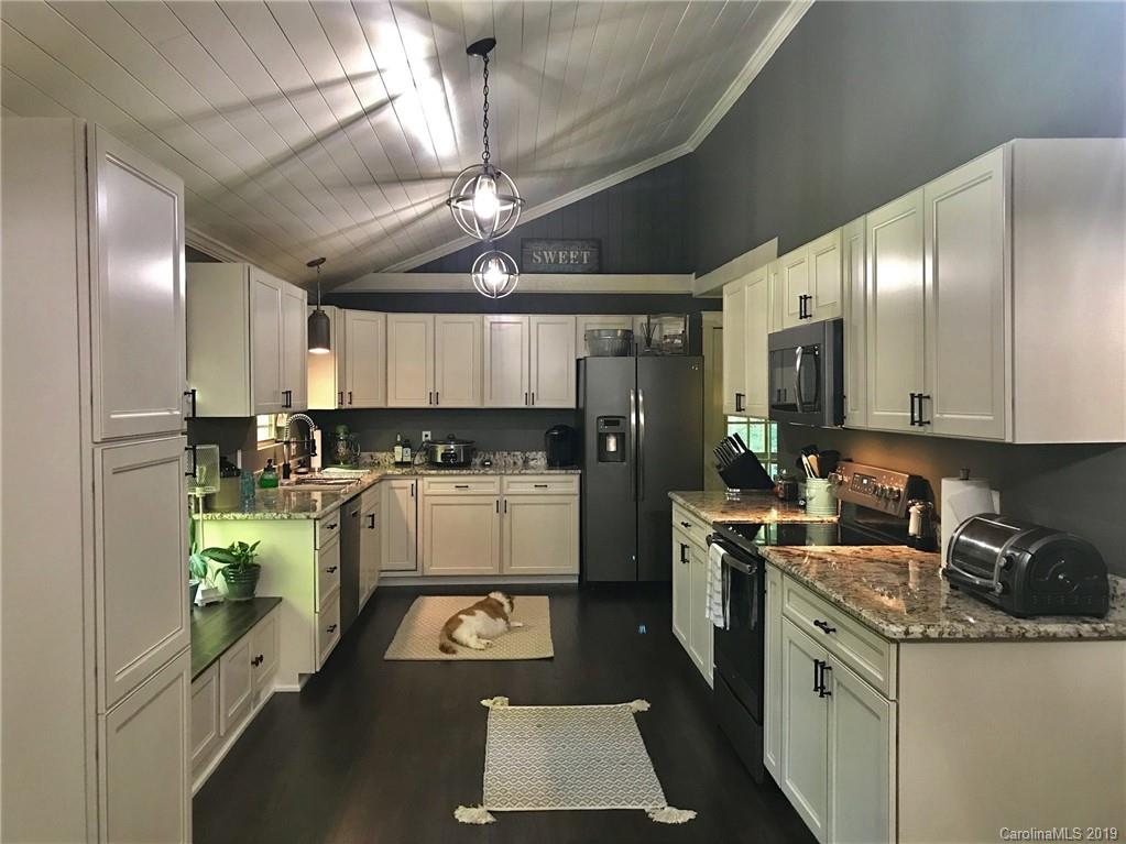 114 Riverview Road Tryon, NC 28782 - Photo 6 of 32 a kitchen that has a lot of cabinets in it and appliances