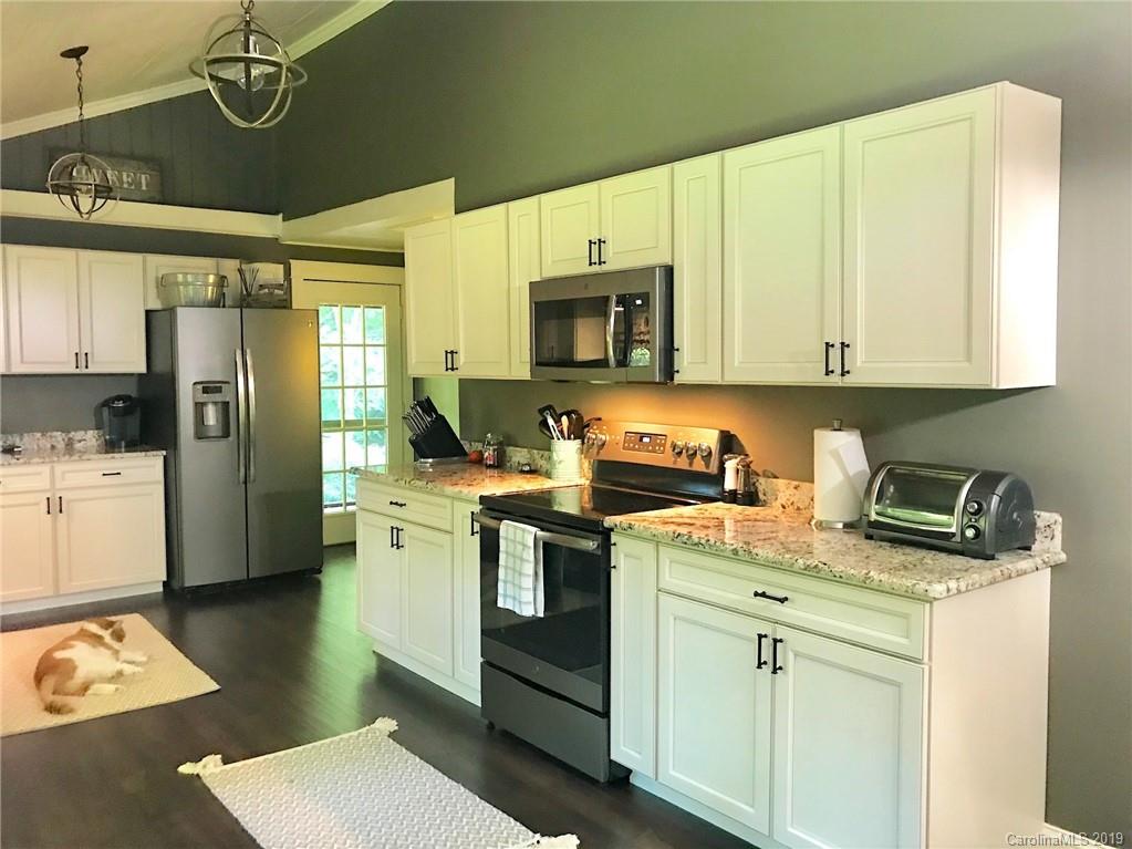 114 Riverview Road Tryon, NC 28782 - Photo 7 of 32 a kitchen with a sink stove and refrigerator