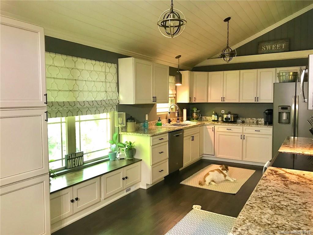114 Riverview Road Tryon, NC 28782 - Photo 8 of 32 a kitchen with white cabinets and window