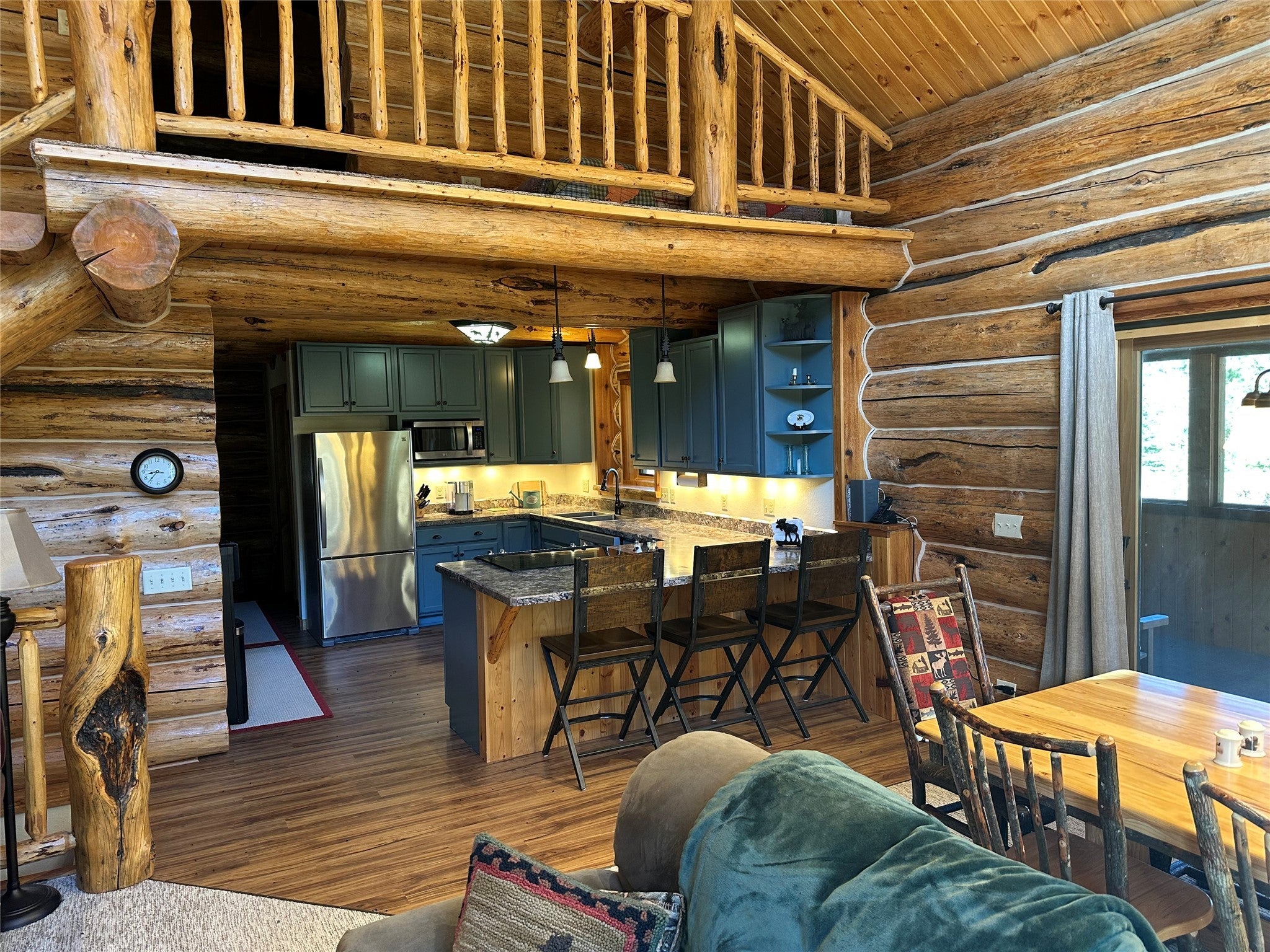 3916 Main Boulder Road McLeod, MT 59052 - Photo 23 of 38 Kitchen featuring rustic walls, decorative light fixtures, high vaulted ceiling, wood ceiling, and stainless steel appliances