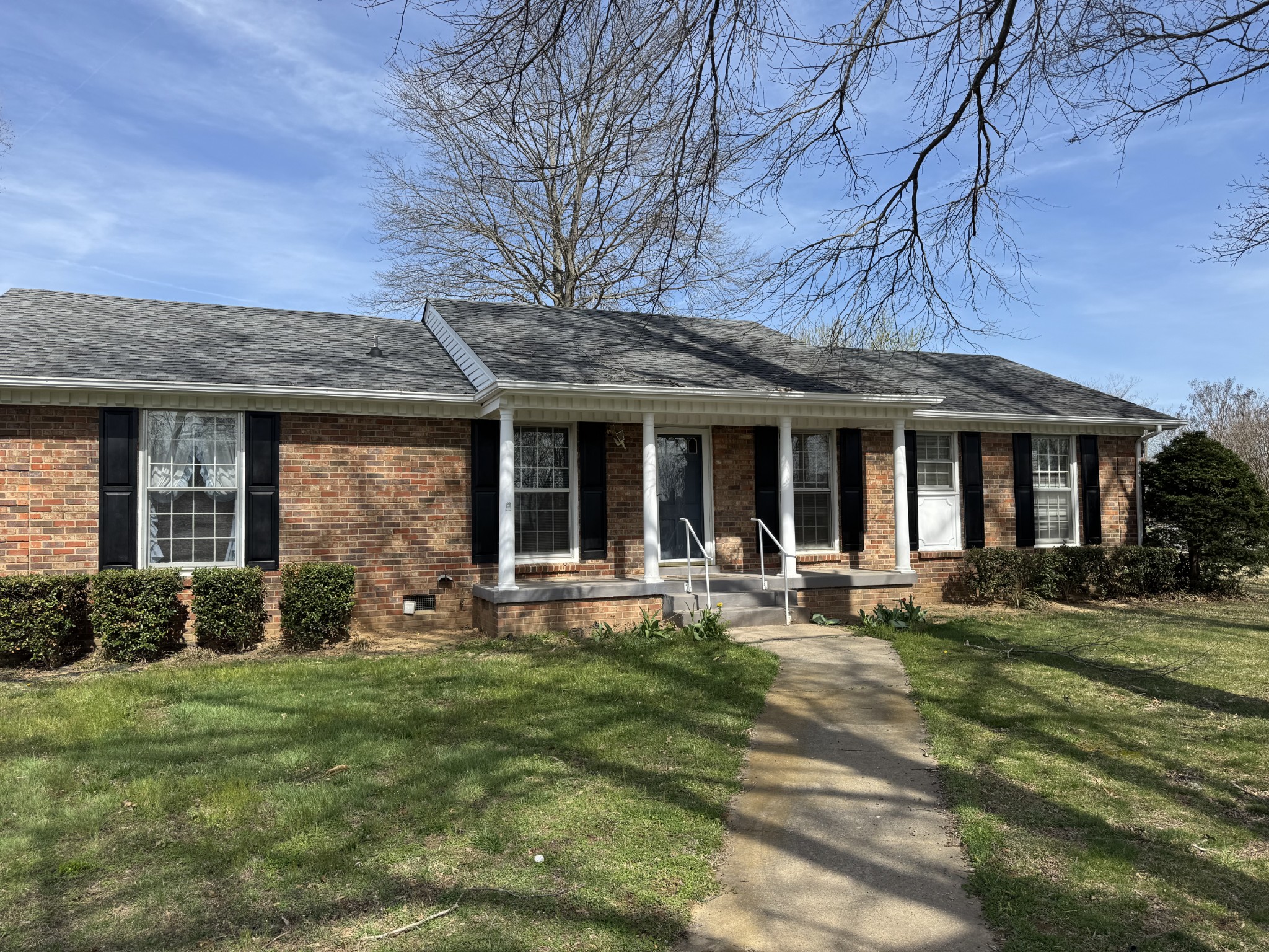 201 Orchard Road Clarksville, TN 37042 - Photo 1 of 24 a front view of a house with garden and porch