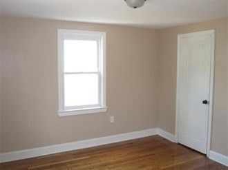 26 Hopewell Road Boston, MA 02136 - Photo 8 of 16 an empty room with wooden floor and a window