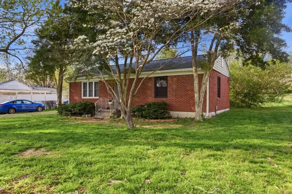 a kitchen with a stove sink and cabinets