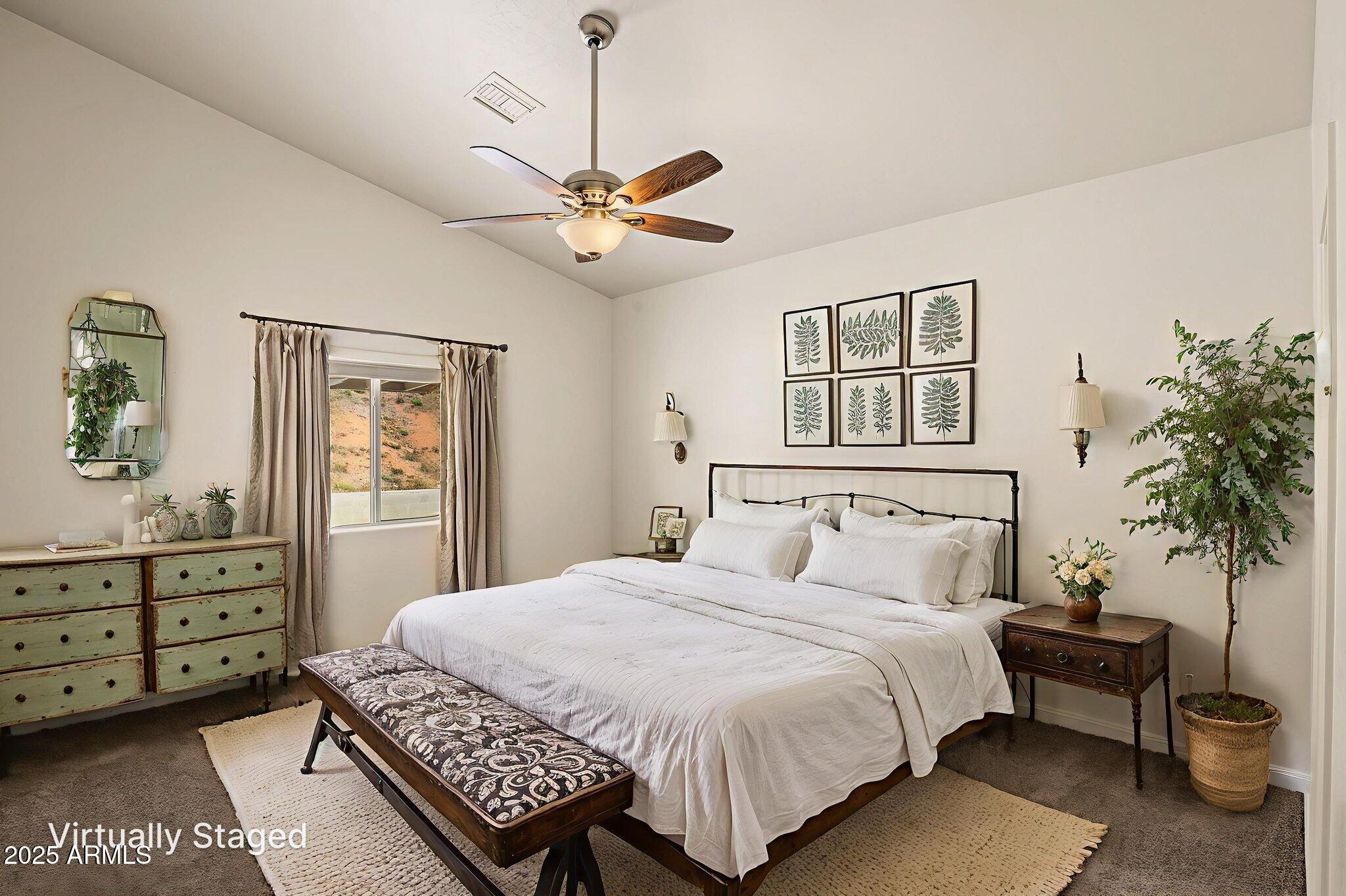 1014 West Summit Street Payson, AZ 85541 - Photo 6 of 21 a bedroom with a large bed and a chandelier