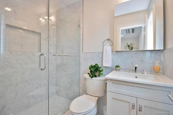 a bathroom with a sink a toilet and a mirror