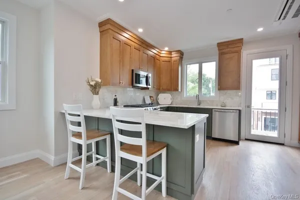 a kitchen with a sink cabinets and window