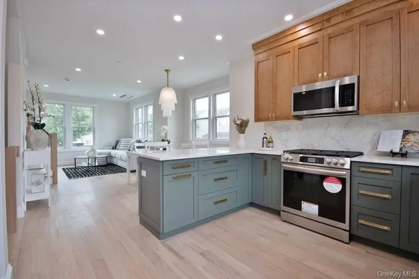 a kitchen with stainless steel appliances granite countertop a stove and a sink