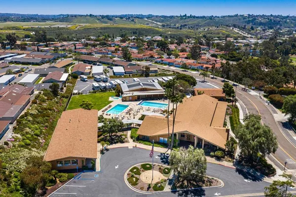 an aerial view of a houses with a swimming pool