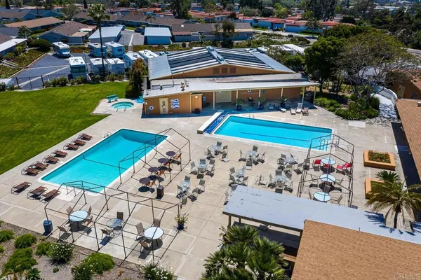 an aerial view of a pool and yard with swimming pool