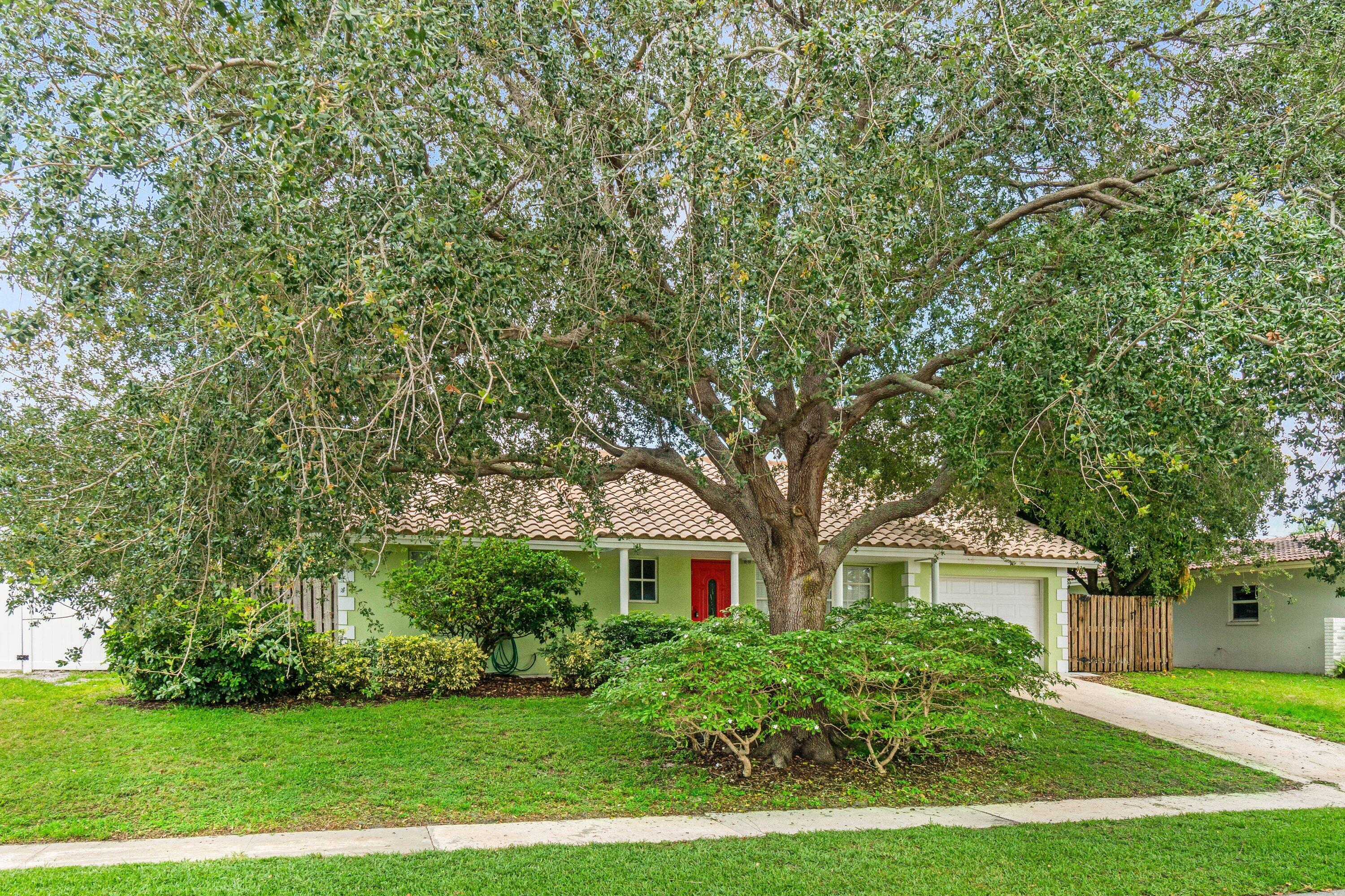 1290 Southwest 8th Street Boca Raton, FL 33486 - Photo 27 of 29 a front view of a house with yard and green space