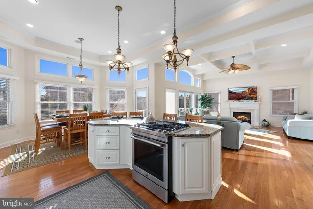 a dining room with furniture a chandelier and wooden floor